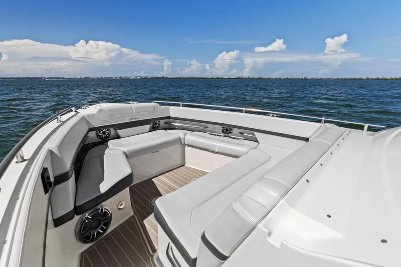 Slide: The Image of 2023 Formula 380 Super Sport Crossover OB boat interior with luxurious seating on open water. - 6
