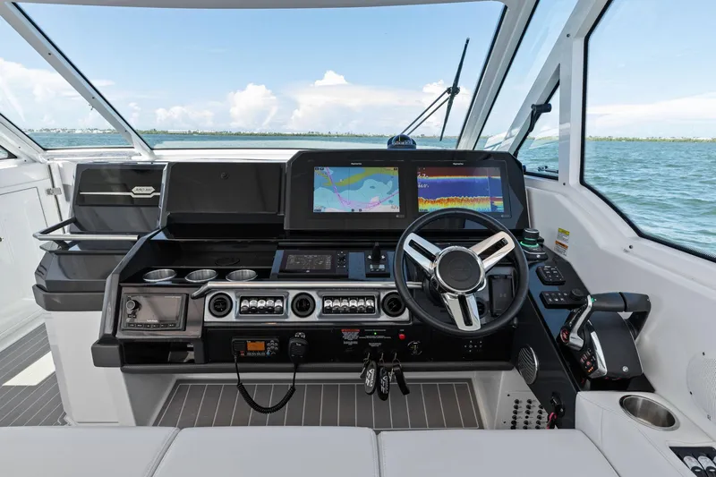 Slide: The Image of 2023 Formula 380 Super Sport Crossover OB helm with advanced navigation displays and controls. - 8