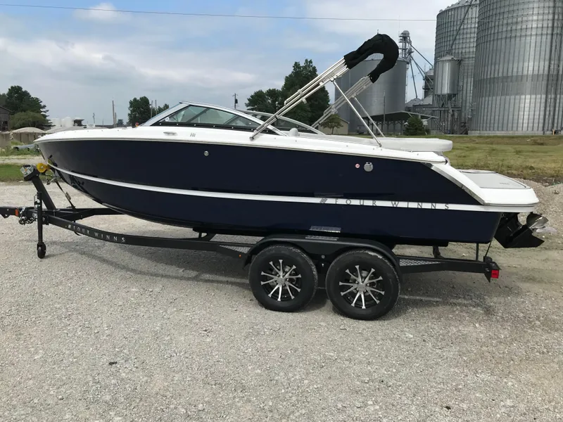 The Image of 2026 Four Winns H-1 FREEDOM boat on trailer, parked outdoors. - 2