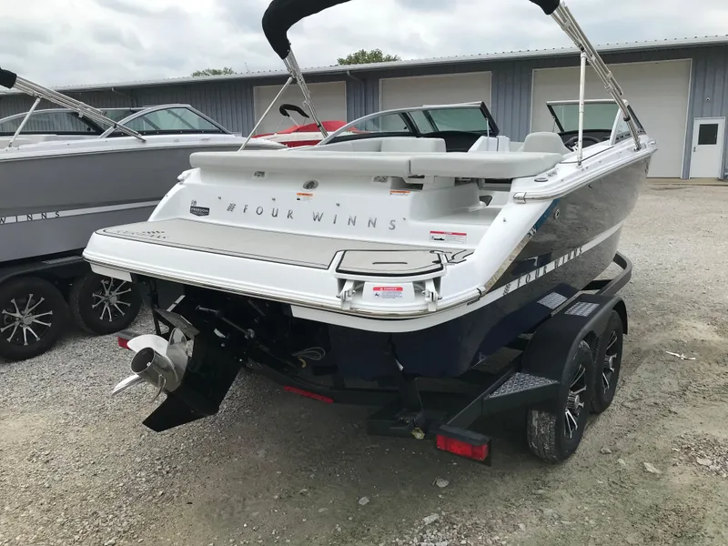 Slide: The Image of 2026 Four Winns H-1 FREEDOM boat on trailer, rear view, parked outdoors. - 8