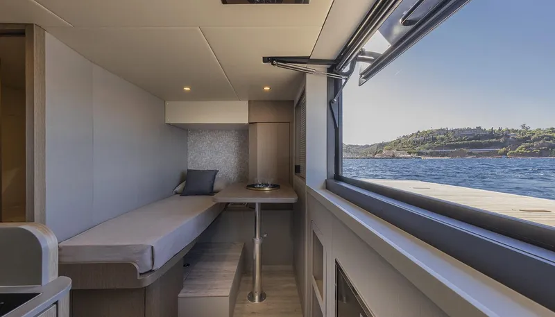 Slide: The Image of Interior of 2026 Absolute NAVETTA 75 yacht with scenic ocean view through large window. - 35