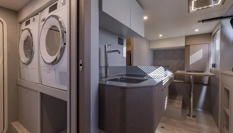 Slide: The Image of Laundry area and kitchenette inside 2026 Absolute NAVETTA 75 yacht, featuring modern appliances and sleek design. - 41
