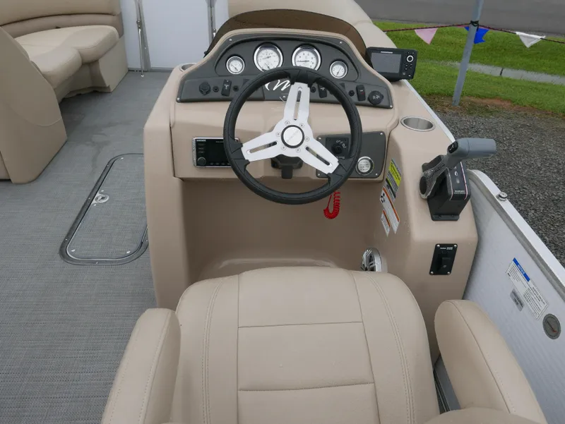 Slide: The Image of 2017 Manitou Aurora VP boat dashboard with steering wheel and controls. - 12