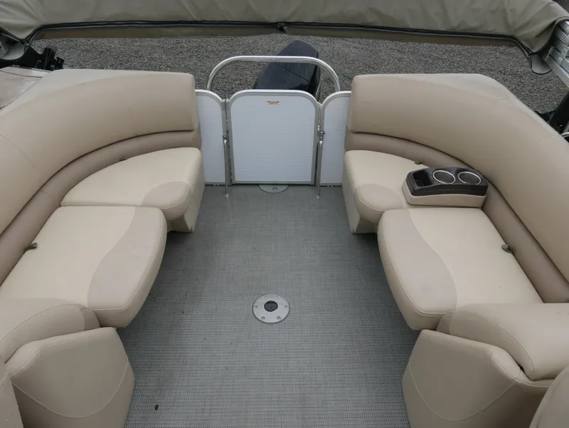 Slide: The Image of 2017 Manitou Aurora VP boat interior with beige seating and cup holders. - 14
