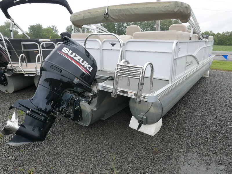Slide: The Image of 2017 Manitou Aurora VP pontoon boat with Suzuki outboard motor on gravel. - 5