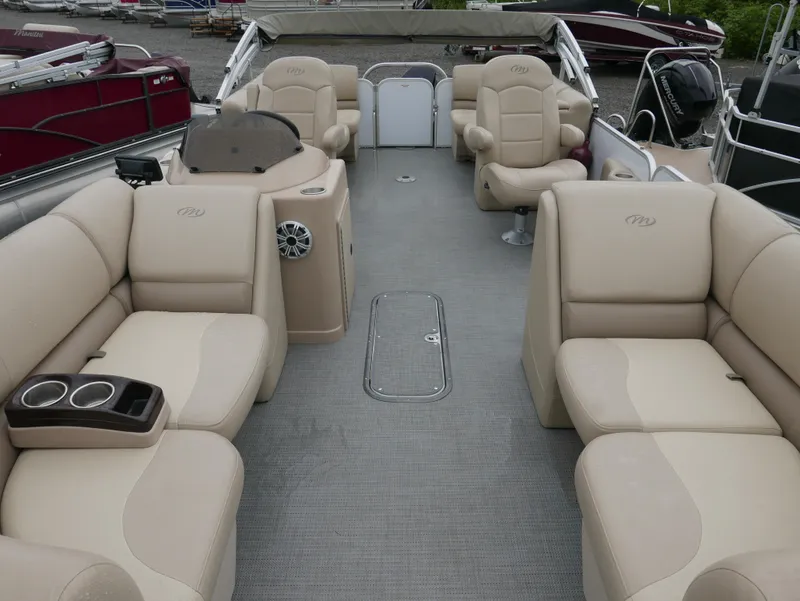 Slide: The Image of 2017 Manitou Aurora VP pontoon boat interior with beige seating and helm. - 6