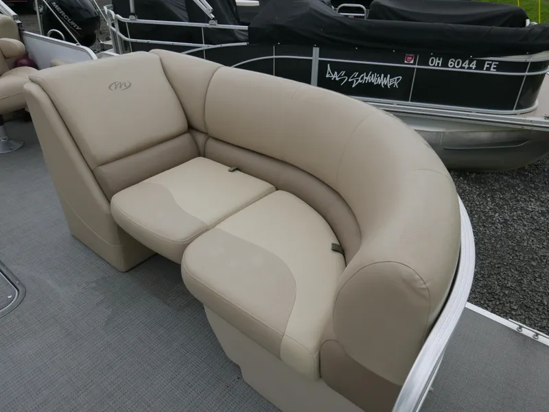 Slide: The Image of 2017 Manitou Aurora VP boat with beige seating on deck. - 7