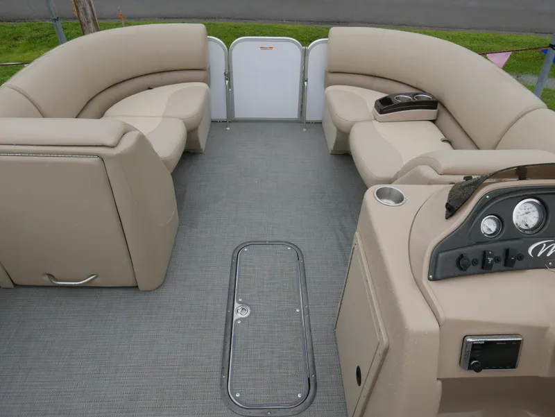 Slide: The Image of 2017 Manitou Aurora VP boat interior with beige seating and control panel. - 9