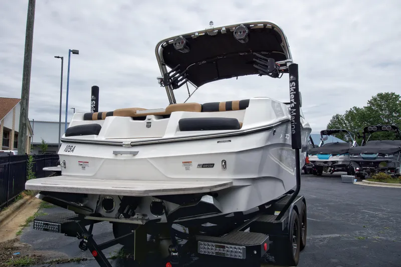 Slide: The Image of 2022 MasterCraft XT22 boat on trailer, rear view, in a parking lot. - 3