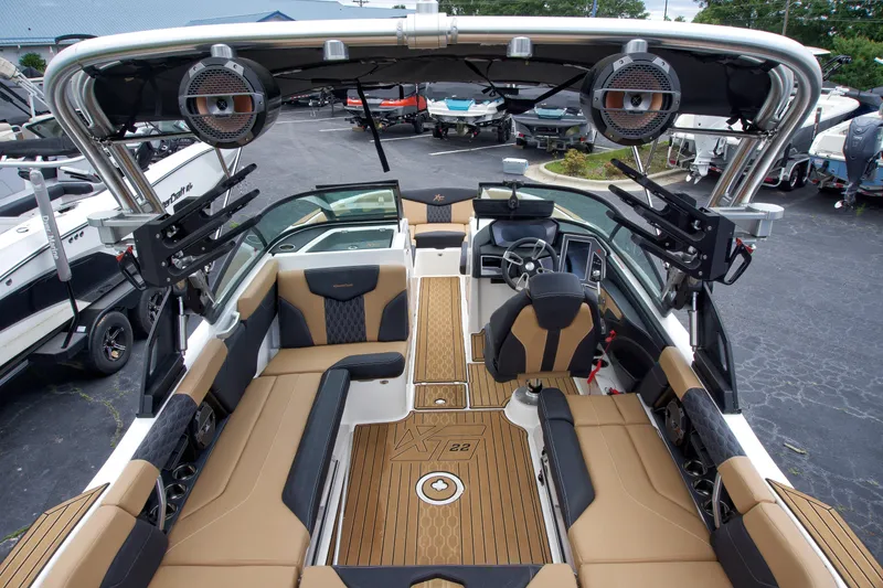 Slide: The Image of 2022 MasterCraft XT22 boat interior with luxury seating and advanced audio system. - 6