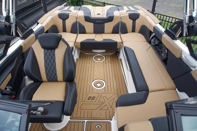 Slide: The Image of Luxurious interior of 2022 MasterCraft XT22 boat with tan and black seating. - 8