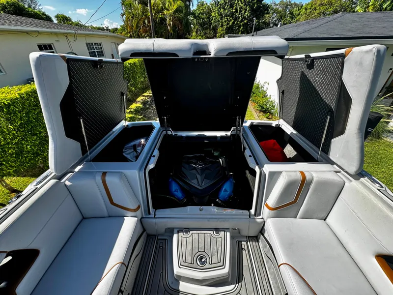 Slide: The Image of 2020 Nautique Super Air Nautique G25 Coastal Edition interior with open storage compartments. - 10