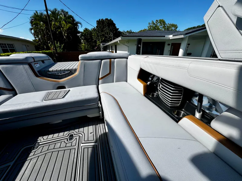 Slide: The Image of 2020 Nautique Super Air Nautique G25 Coastal Edition interior with luxurious seating and cup holders. - 14