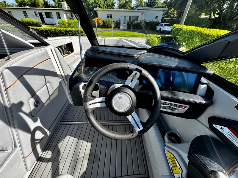 Slide: The Image of 2020 Nautique Super Air Nautique G25 Coastal Edition cockpit with steering wheel and dashboard. - 19