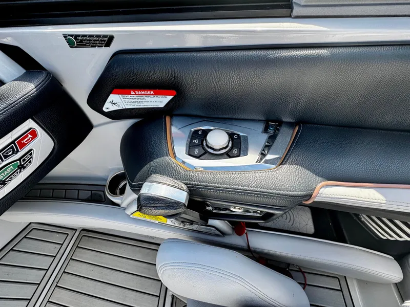 Slide: The Image of 2020 Nautique Super Air Nautique G25 Coastal Edition dashboard controls and warning labels. - 20