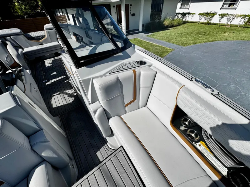 Slide: The Image of 2020 Nautique Super Air Nautique G25 Coastal Edition interior with luxurious seating and cup holders. - 25