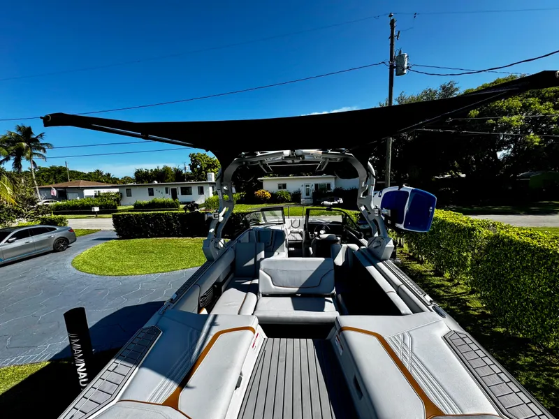 Slide: The Image of 2020 Nautique Super Air Nautique G25 Coastal Edition boat with spacious seating and canopy. - 8