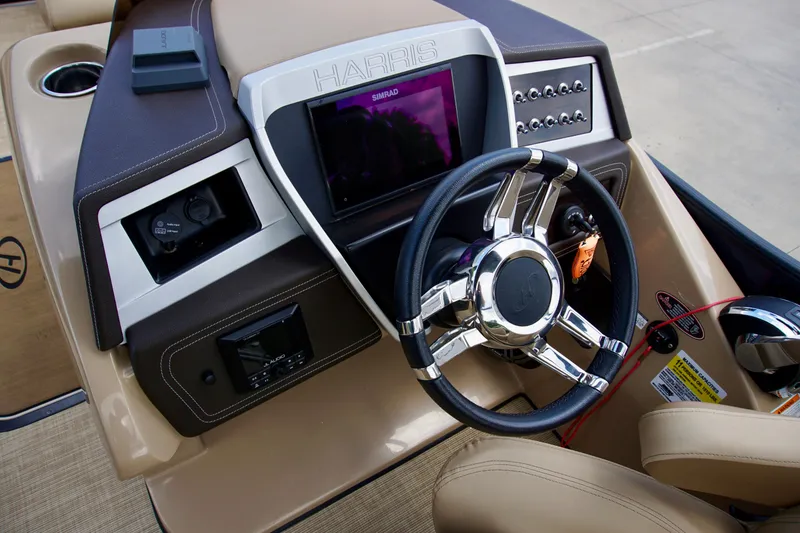 Slide: The Image of 2020 Harris Grand Mariner 230 dashboard with steering wheel and control panel. - 11