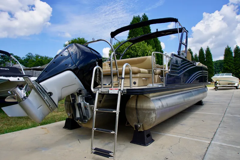 Slide: The Image of 2020 Harris Grand Mariner 230 pontoon boat with powerful outboard motor, parked on concrete. - 4