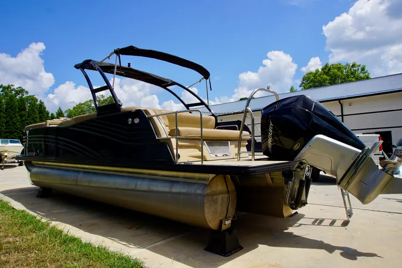 Slide: The Image of 2020 Harris Grand Mariner 230 pontoon boat with Mercury outboard motor, parked outdoors. - 5