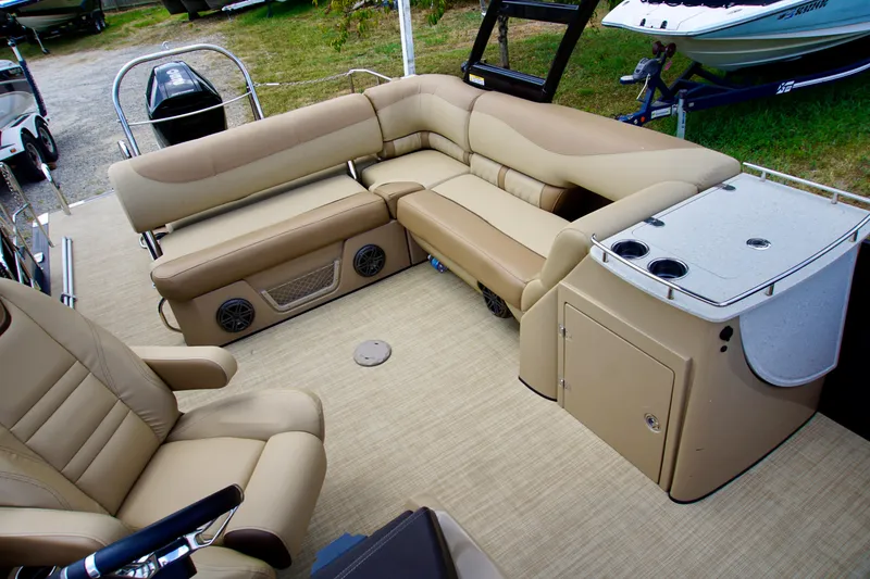 Slide: The Image of 2020 Harris Grand Mariner 230 interior with beige seating and storage console. - 7