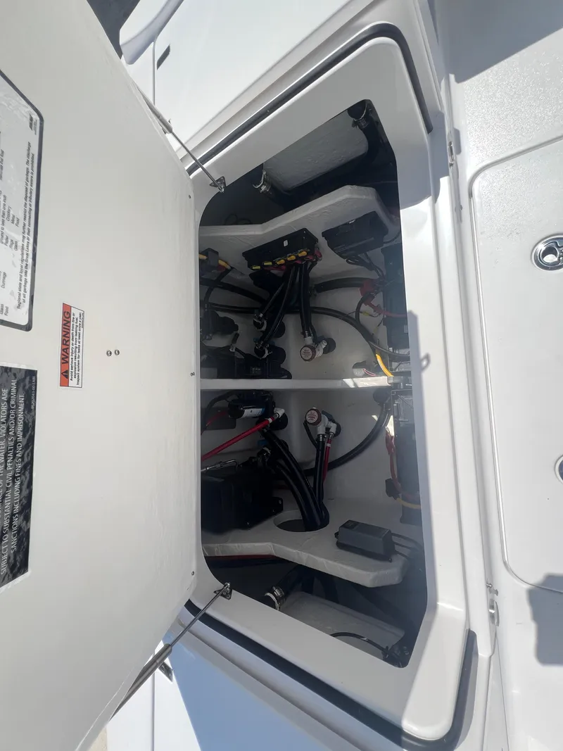 Slide: The Image of Open hatch of 2026 Blackfin 262 HB boat showing internal wiring and components. - 10