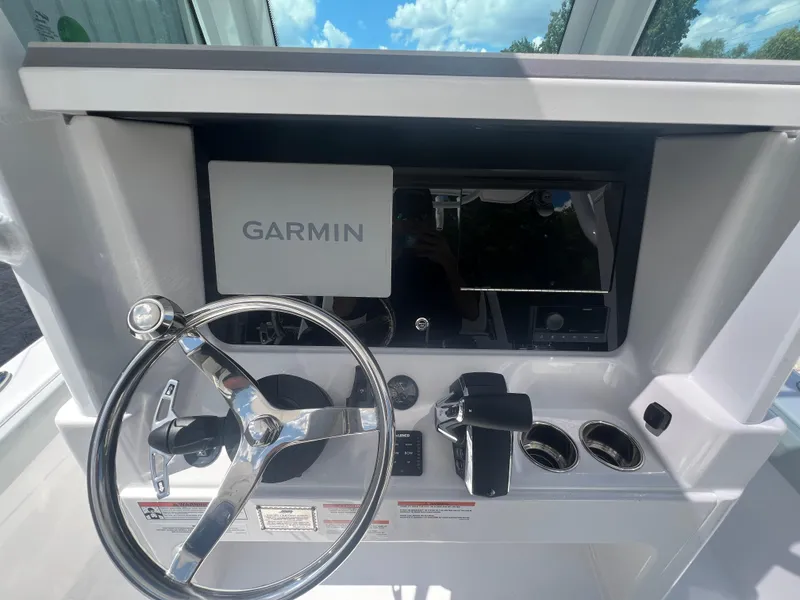 Slide: The Image of Helm of 2026 Blackfin 262 HB boat with Garmin navigation system and steering wheel. - 12