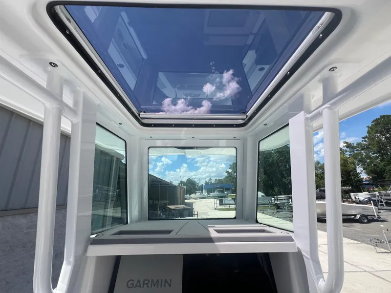 Slide: The Image of Interior view of 2026 Blackfin 262 HB boat with glass roof and Garmin equipment. - 13
