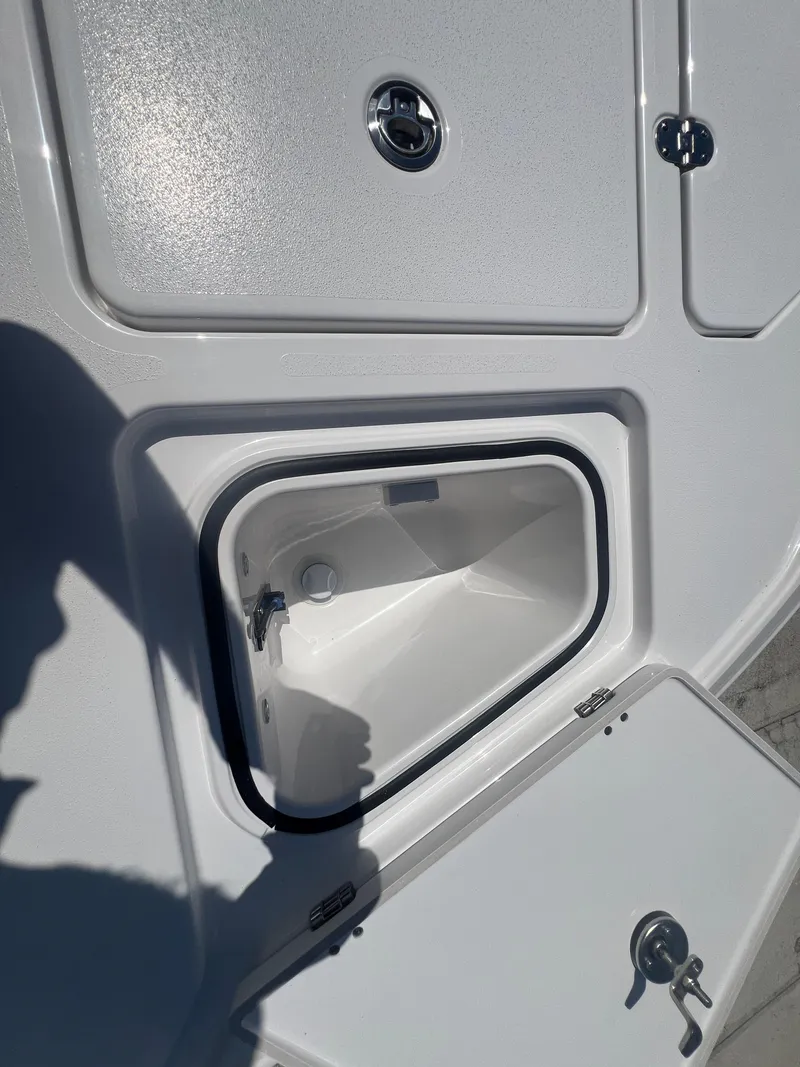 Slide: The Image of Storage compartment on a 2026 Blackfin 262 HB boat, featuring sleek white design. - 19