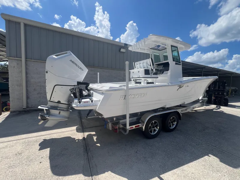 Slide: The Image of 2026 Blackfin 262 HB boat with Mercury engine on trailer, parked outdoors. - 3