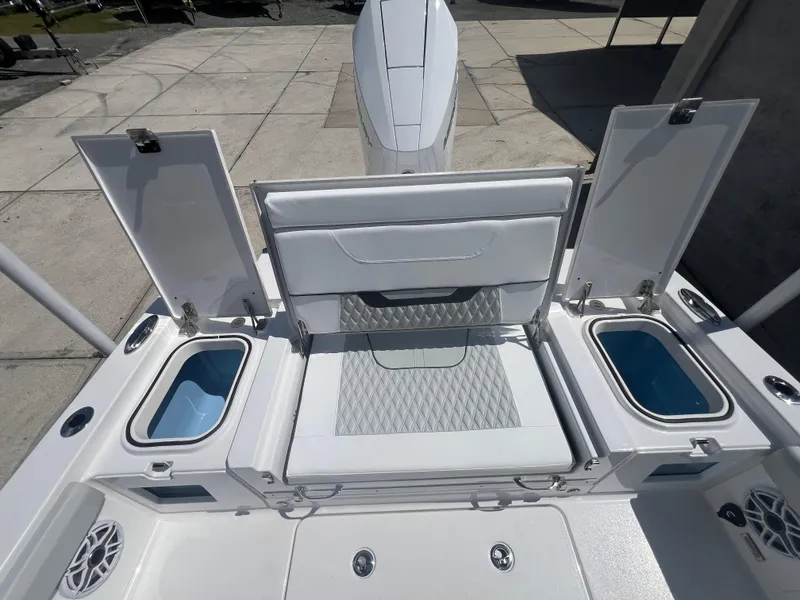 Slide: The Image of 2026 Blackfin 262 HB boat interior with open storage compartments and cushioned seating. - 8