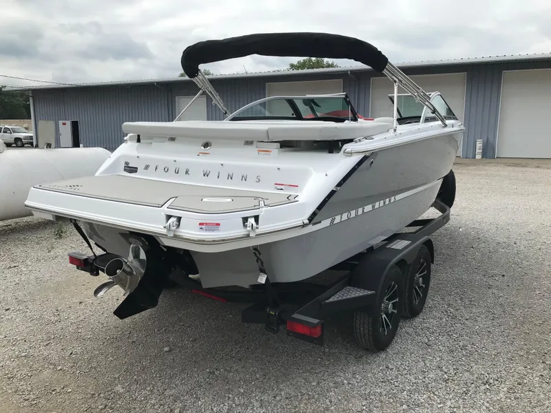 Slide: The Image of 2026 Four Winns H-2 FREEDOM boat on trailer, parked outdoors. - 11