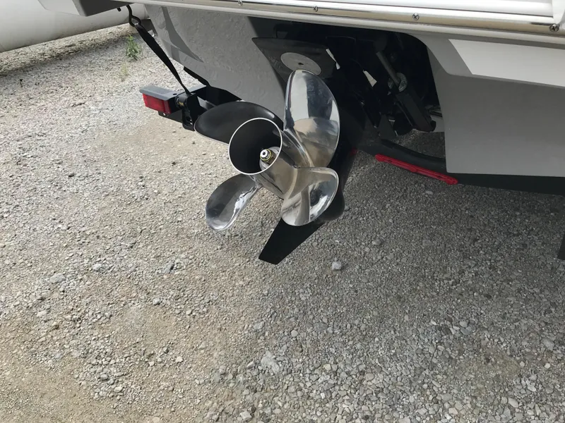 Slide: The Image of 2026 Four Winns H-2 FREEDOM boat propeller on gravel surface. - 15