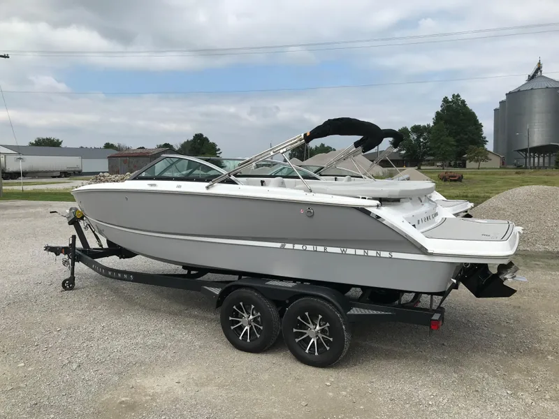 Slide: The Image of 2026 Four Winns H-2 FREEDOM boat on trailer, parked outdoors. - 5