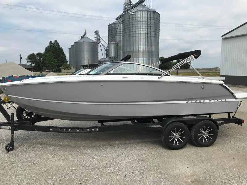 Slide: The Image of 2026 Four Winns H-2 FREEDOM boat on trailer, industrial background. - 6