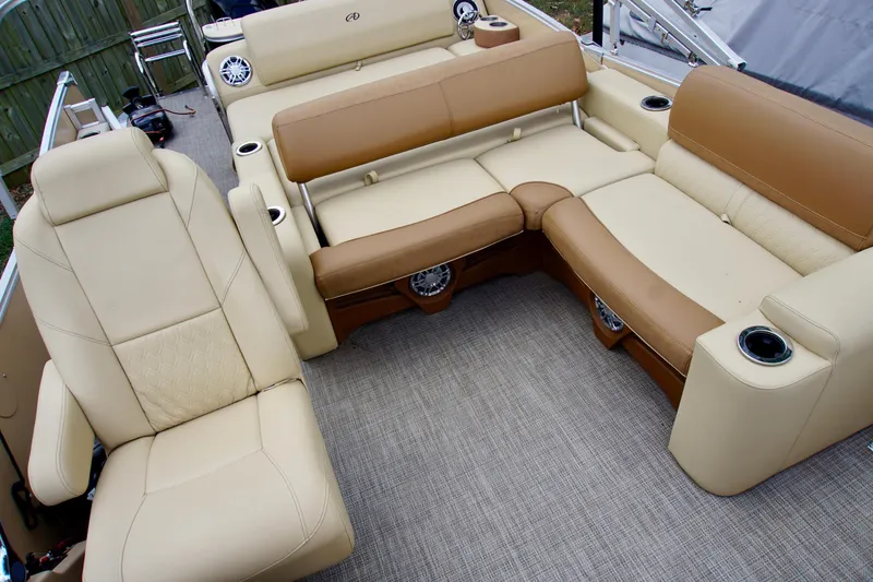 Slide: The Image of 2020 Avalon Catalina Platinum Rear Lounger boat interior with beige and brown seating. - 10