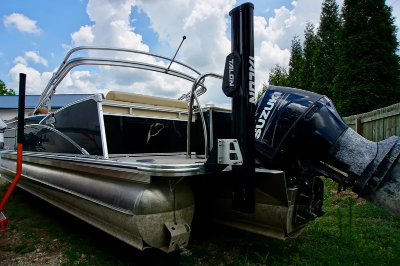 Slide: The Image of 2020 Avalon Catalina Platinum Rear Lounger boat with Suzuki motor, parked outdoors. - 3