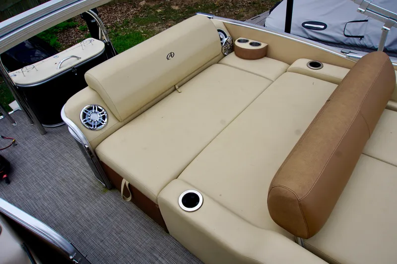 Slide: The Image of 2020 Avalon Catalina Platinum Rear Lounger boat with beige seating and cup holders. - 8