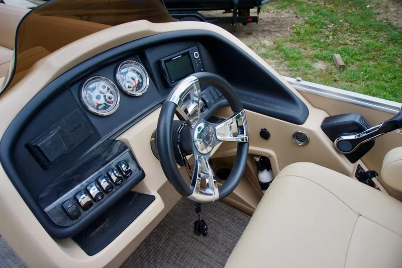 Slide: The Image of 2020 Avalon Catalina Platinum boat dashboard with steering wheel and control panel. - 9
