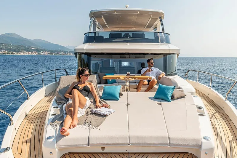 Slide: The Image of Luxury Absolute NAVETTA 70 yacht, 2026 model, with people relaxing on deck in sunny ocean setting. - 10