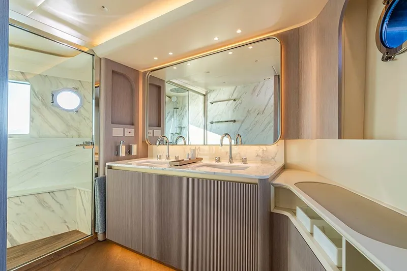Slide: The Image of Luxurious bathroom in 2026 Absolute NAVETTA 70 yacht, featuring dual sinks and elegant marble accents. - 17