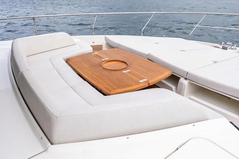 Slide: The Image of Luxurious seating area on the 2026 Absolute NAVETTA 70 yacht with wooden table. - 23