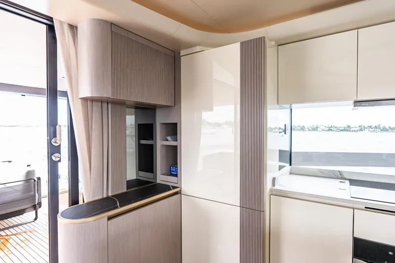 Slide: The Image of Modern kitchen interior on Absolute NAVETTA 70 yacht, 2026 model, featuring sleek cabinetry and ocean view. - 29