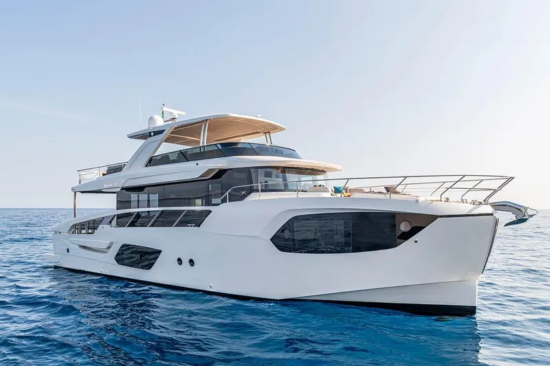 Slide: The Image of Luxurious 2026 Absolute NAVETTA 70 yacht cruising on calm blue waters. - 3