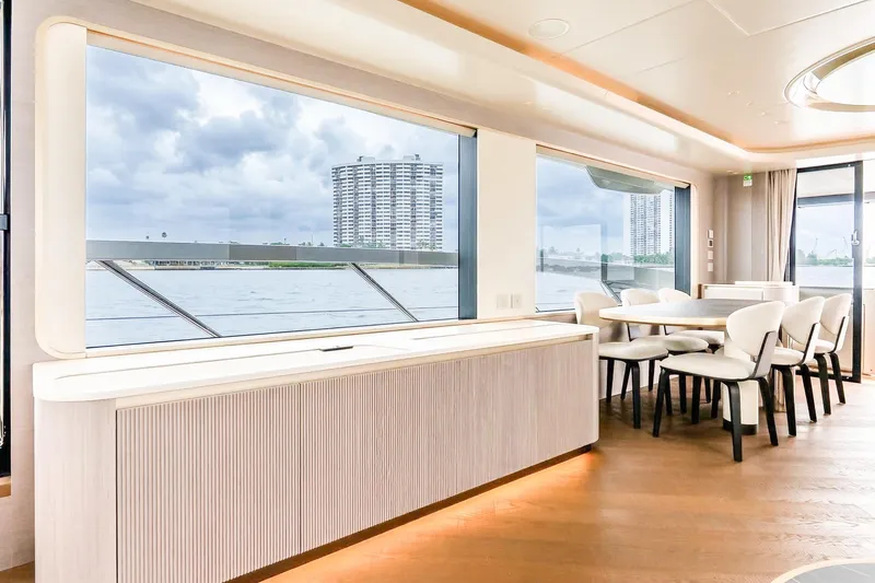 Slide: The Image of Luxurious interior of 2026 Absolute NAVETTA 70 yacht with elegant dining area and panoramic windows. - 39