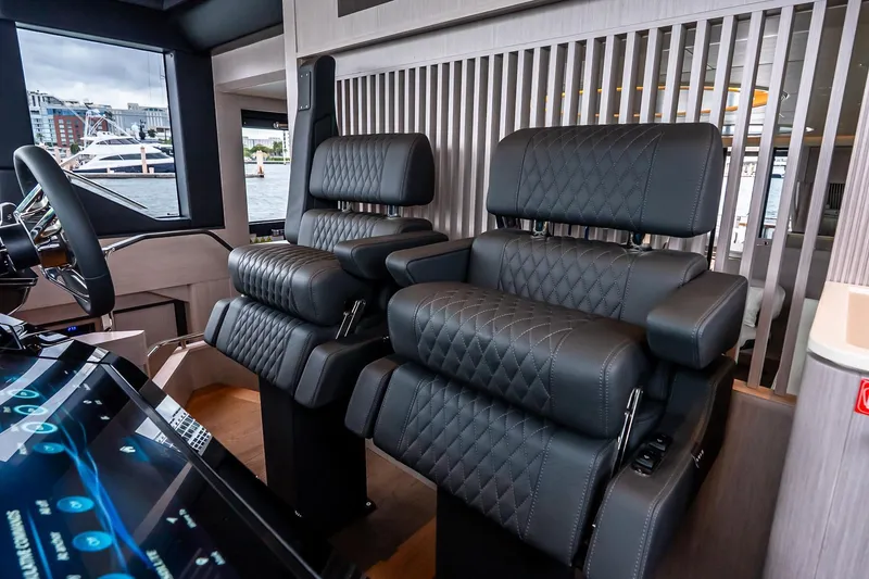 Slide: The Image of Luxurious helm seats on the 2026 Absolute NAVETTA 70 yacht, featuring quilted leather design. - 42