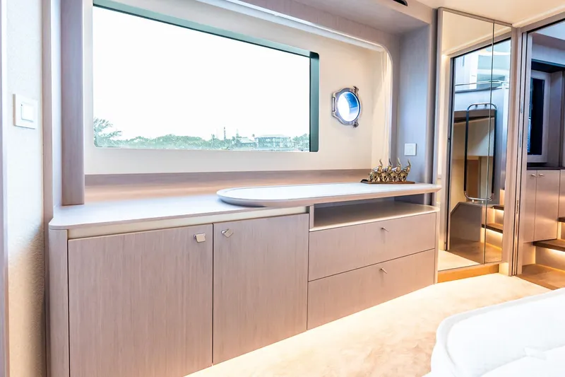 Slide: The Image of Luxurious interior of 2026 Absolute NAVETTA 70 yacht with elegant cabinetry and large window. - 52