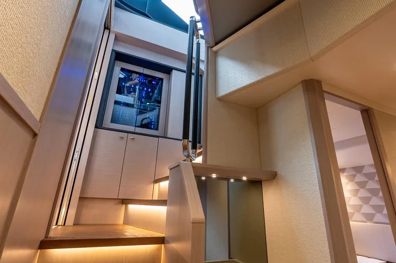 Slide: The Image of Interior staircase of 2026 Absolute NAVETTA 70 yacht, featuring modern design and ambient lighting. - 55