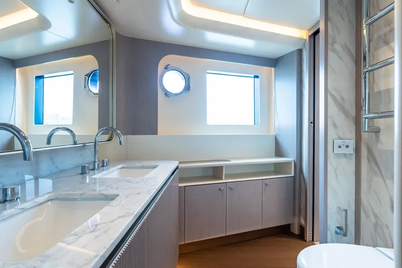 Slide: The Image of Luxurious bathroom interior of 2026 Absolute NAVETTA 70 yacht with modern fixtures and porthole window. - 58