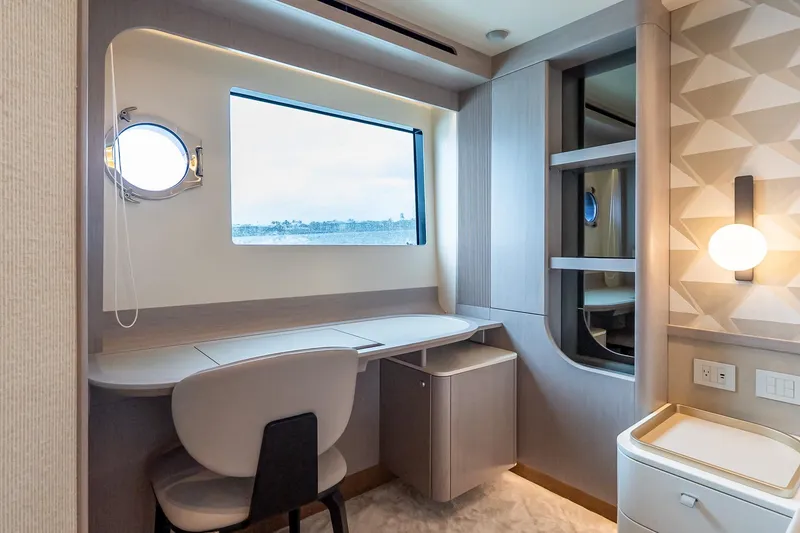 Slide: The Image of Luxurious interior of 2026 Absolute NAVETTA 70 yacht with modern desk and window view. - 65